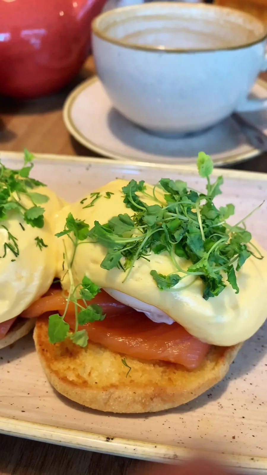Poached eggs and hollandaise on toasted muffins with smoked salmon and fresh herbs at Ethos, Havant